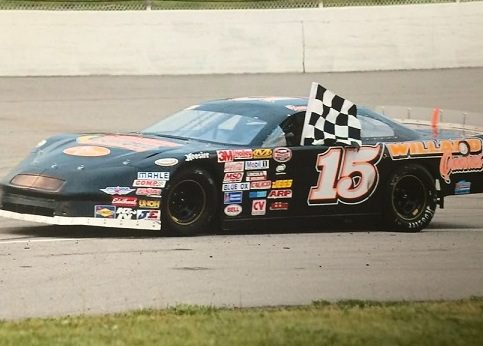 A racecar with the Metaltech logo takes a victory lap