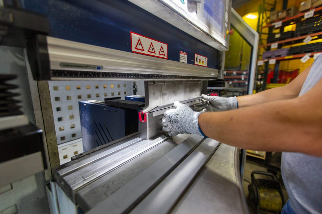 A Metaltech employee operates a press break in the fabrication shop
