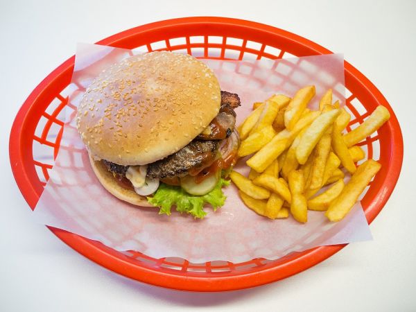 A hamburger and french fries in a basket