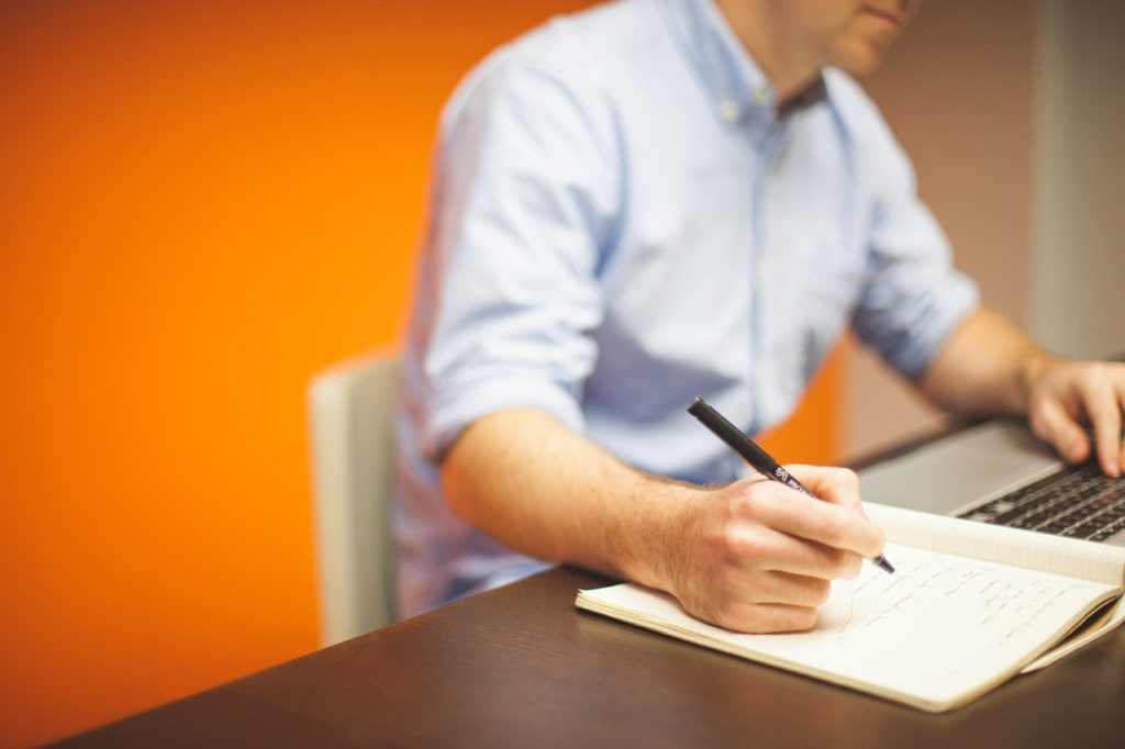 A man sitting at his desk thinking about ISO Certification