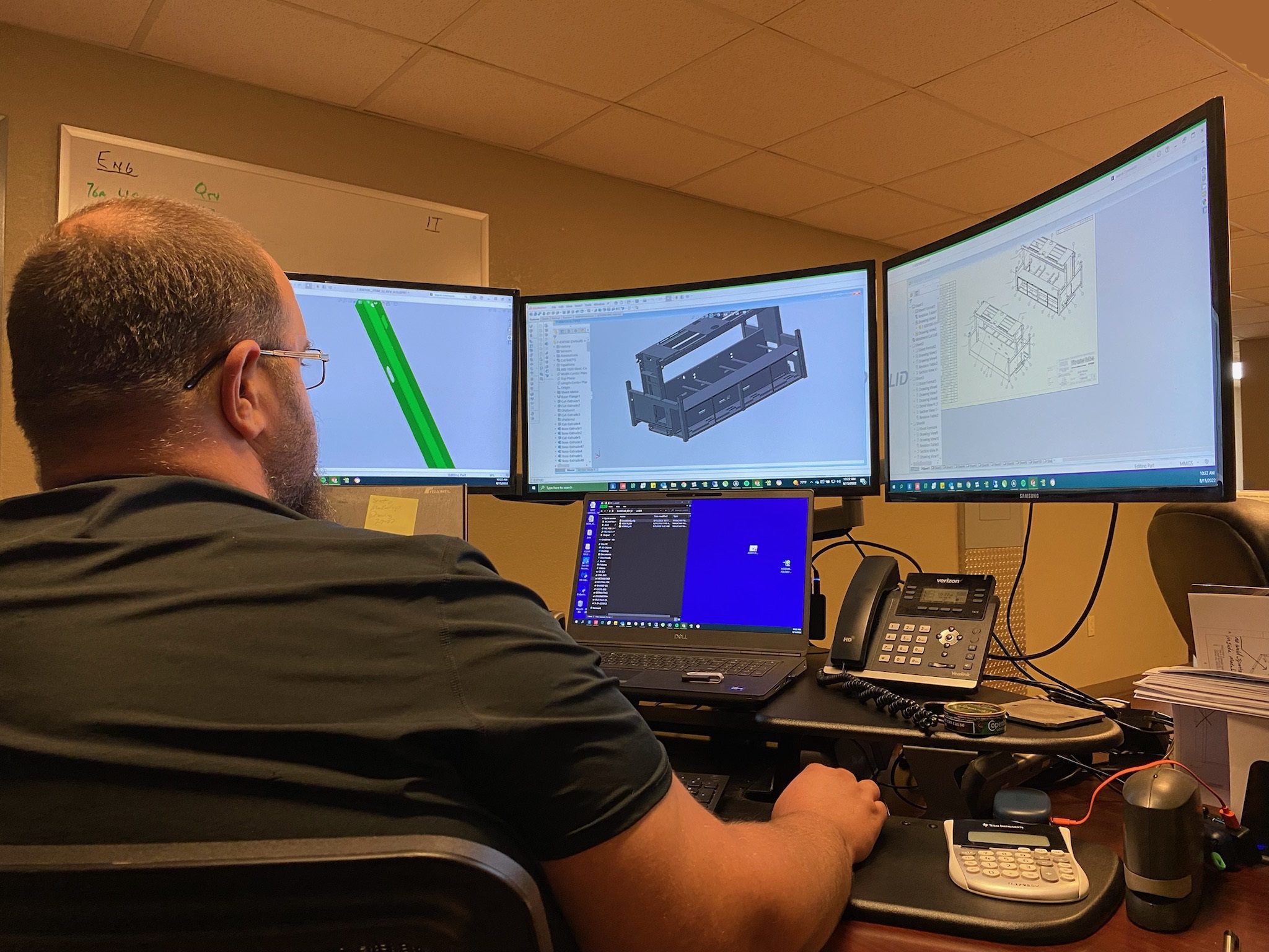 A Metaltech team member uses a solid modeling program to show metal parts in 3-D.