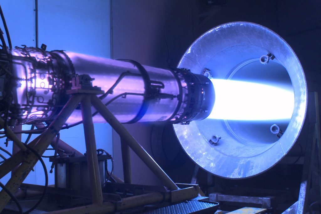 A jet engine burns with blue flame during a jet engine thrust test.