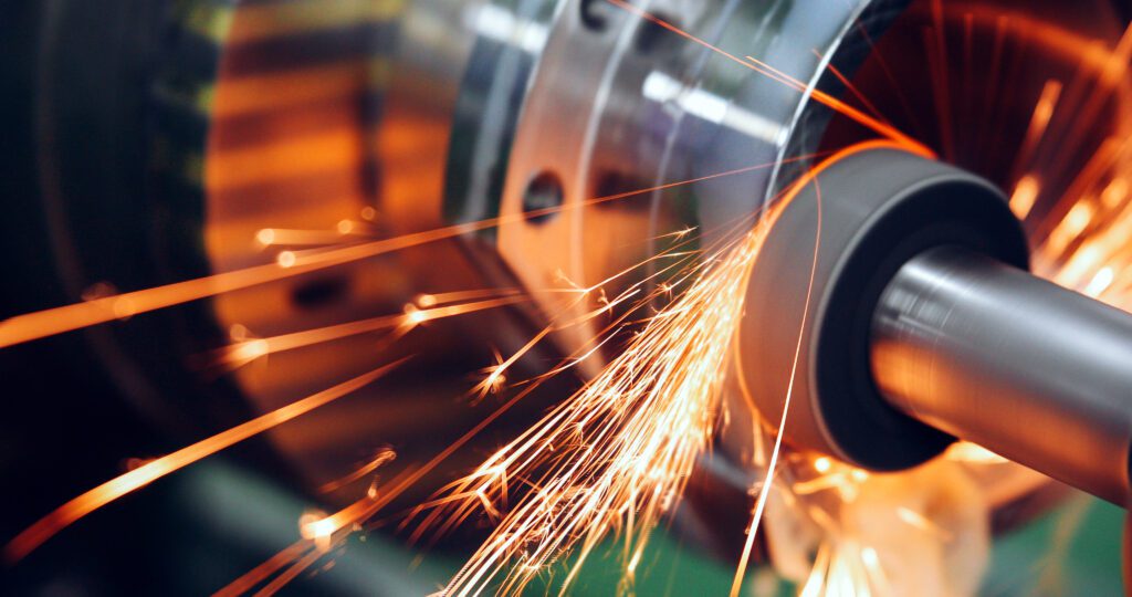 sparks flying while machine griding and finishing metal in factory